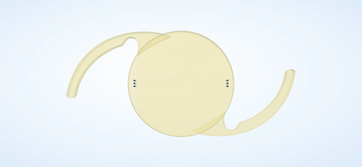 A yellow-tinted, blue-light-filtering toric intraocular lens with axis markings and two curved supporting arms